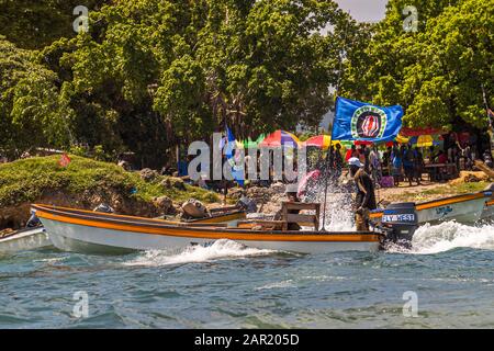 Locals from Bougainville in a small ferry boat with the independence flag from Papua New Guinea hoisted