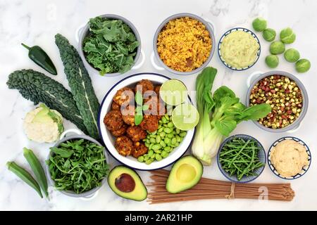 Vegan super food collection with foods high in antioxidants, vitamins, minerals, protein,  smart carbs, omega 3 and fibre. Flat lay on marble. Stock Photo
