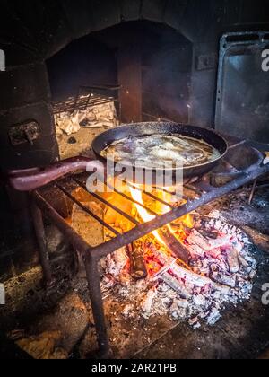 Atlantic horse mackerel Frying on a rustic fire pan - a Portuguese traditional food Stock Photo