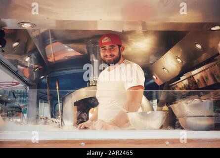 A chef in a street food van Stock Photo