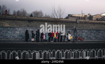 People wait for a bus during a local ceasefire related to evacuation ...