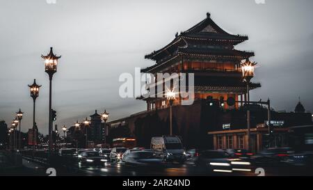 Beijing, China - December 29 2018: Beijing Zhengyang Gate at a night view. Long exposure of a traffic road creating car light trails. Stock Photo