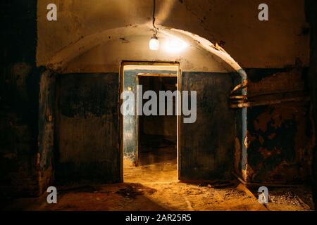 Old dark creepy abandoned basement with lamp Stock Photo