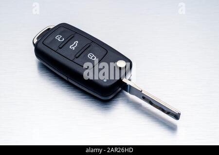 New car key fob on aluminium background. Repair of broken or damaged remote key fob of any vehicle car service concept.- Image Stock Photo
