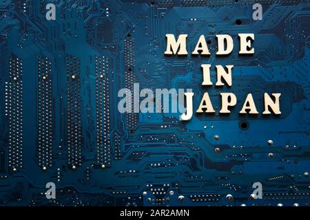 Sign Made in Japan on a blue electronic printed circuit board. Background with copyspace for design Stock Photo