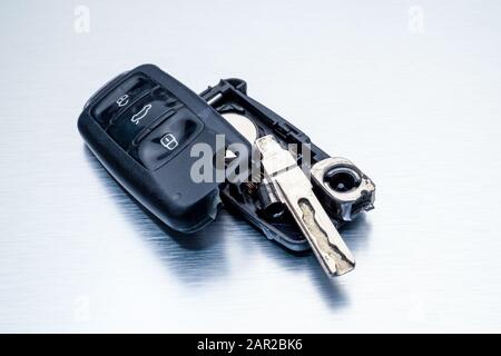 Close-up dirty broken or damaged car key fob on aluminium background locksmith service.- Image Stock Photo