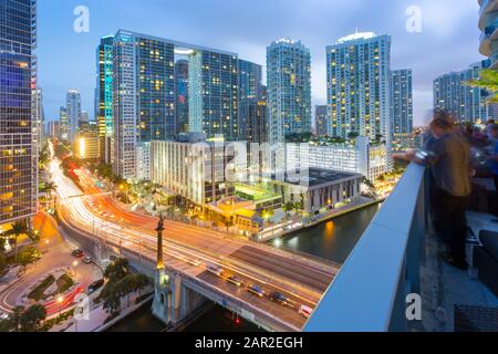 Rooftop bar overlooking traffic on Birckell Avenue at dusk, Miami, Florida, United States of America, North America