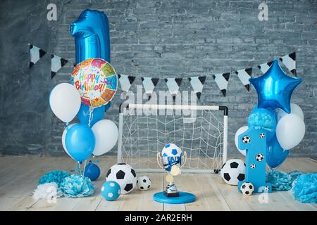 Festive background decoration for birthday, letters saying one and blue balloons in studio, Boy Birthday .Cake Smash first year concept. birthday gree Stock Photo