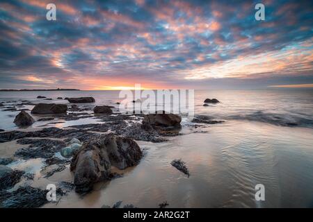 Dramatic sunset over the beach at Llandanwg near Barmouth on the north coast of Wales Stock Photo