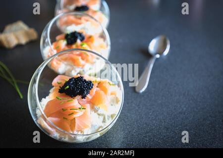 verrine salmon lumpfish egg fresh cheese and avocado bed in the kitchen Stock Photo