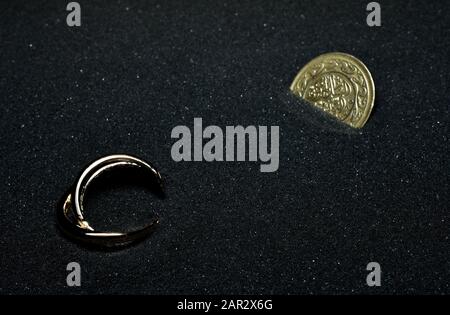 gold things cover into the sand Stock Photo