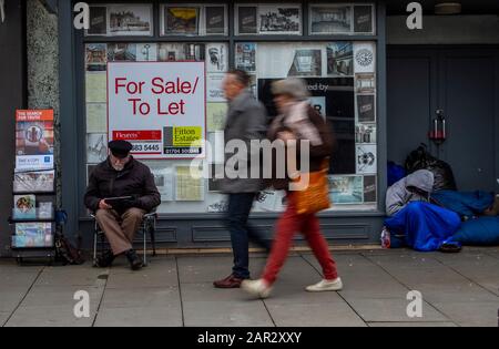 Street life, homelessness in retail premises; Man sleeping in shop ...