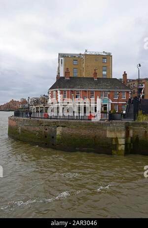 Gordon Ramsay restaurant The Narrow by the Thames path at the entrance to Limehouse ship lock in eastern London, UK, with block of flats behind Stock Photo