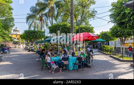 San Pedro Tlaquepaque, Jalisco, Mexico - November 23, 2019: Tourists, Locals and street vendors at the hidalgo garden Stock Photo