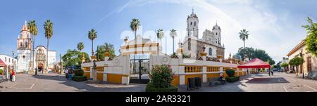 San Pedro Tlaquepaque, Jalisco, Mexico - November 23, 2019: View of the Parish of St. Peter the Apostle, and Our Lady of Solitude Sanctuary churches, Stock Photo