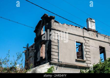 Old burnt and destroyed countryside house closeup in clear sunny day Stock Photo