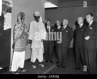 Opening of an exhibition on the Wah, an agricultural community in Pakistan, at the Royal Institute for the Tropics by Alderman Carriage in Amsterdam  Alderman Carriage in the company of a number of men while viewing one of the setups Date: 25 November 1965 Location: Amsterdam, Noord-Holland Keywords: population groups, traditional costumes, exhibitions Person name: Carriage, P.J. Stock Photo