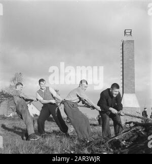 The work of the Stichting War Foster Children in the field of care of children of N.S.B.-ers  Boys engaged in harvesting of tree stumps. In the background a chimney Date: October 1945 Keywords: Education, World War II Stock Photo