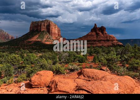 Bell Rock and Courthouse Butte in Sedona, Arizona with storm clouds and sunlight Stock Photo