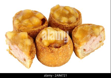 Crusty apple sauce topped mini pork pies isolated on a white background Stock Photo