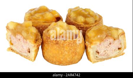 Crusty apple sauce topped mini pork pies isolated on a white background Stock Photo