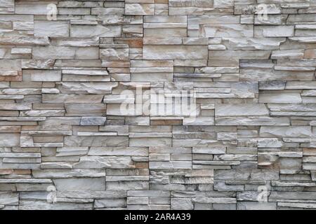 Stone background walls are stacked. Stone cladding background and wallpaper. Stock Photo