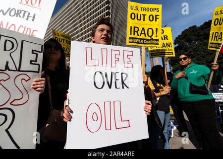 A protester holds a placard that says life over oil during the demonstration.No War in Iran protest against the Trump Administration’s military actions and economic sanctions against Iran. Organizers called on Trump to withdraw U.S. troops from Iraq and not to drag the U.S. into a war in the Middle East. Stock Photo