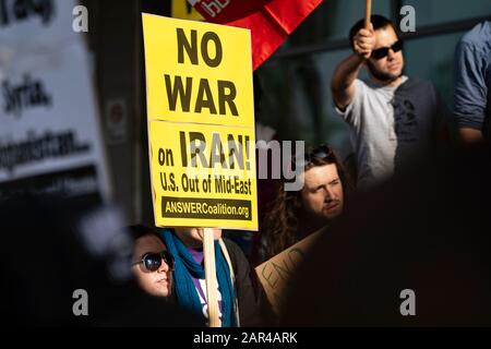 A protester holds a placard that says No war on Iran U.S out of Mid-east during the demonstration.No War in Iran protest against the Trump Administration’s military actions and economic sanctions against Iran. Organizers called on Trump to withdraw U.S. troops from Iraq and not to drag the U.S. into a war in the Middle East. Stock Photo