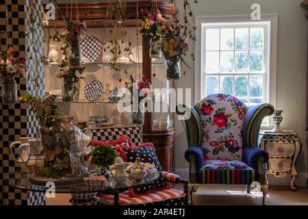July 27, 2019 - Aurora, NY, USA: Interior of MacKenzie-Childs Shop with furniture and multicolored home decor, Courtly Royal Check Enamel tableware Stock Photo