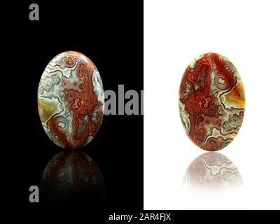 Oval shape cabochon crazy lace agate on a black and white backgrounds. Stock Photo