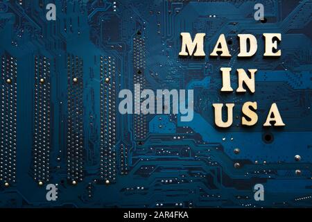 Made in Usa. Inscription on a blue electronic printed circuit board. American electronics industry concept. Background with copyspace for design Stock Photo