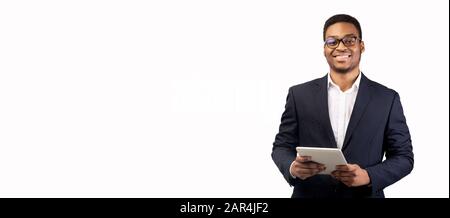 Smiling afro man standing with tablet at studio Stock Photo