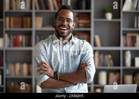 Cheerful confident african young businessman standing at home office, portrait Stock Photo