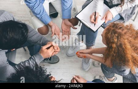 Diverse people sharing their problems at group therapy session, top view Stock Photo