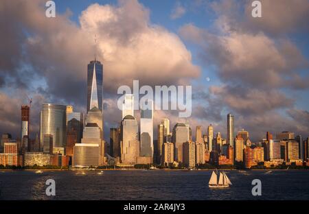 Lower Manhattan Skyline and moon rising at Golden Hour, NYC, USA Stock Photo