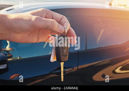 Man's hand holding a key from the car close-up Stock Photo