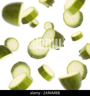 Flying squashes slices isolated on white background Stock Photo