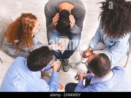 Group of diverse people discussing their problems in trust circle Stock Photo