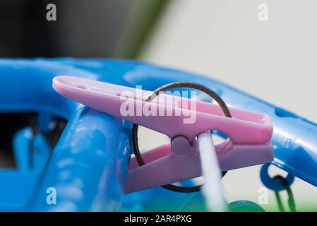 Pink plastic clothing peg hanging pin hook clip. Close up macro shot. Stock Photo