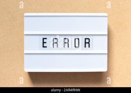 White lightbox with word error on wood background Stock Photo