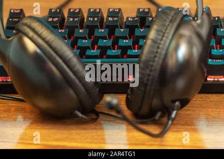 headphones lying at the keyboard Stock Photo