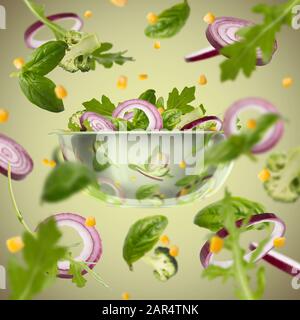 Healthy vegetarian eating and cooking with various flying chopped vegetables Stock Photo