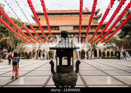 Po Lin Monastery courtyard with traditional Chinese New Year decorations and Hall of Great Hero, Lantau Island, Hong Kong Stock Photo