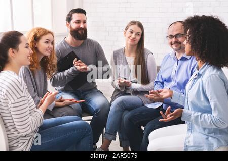 Young woman sharing her story at group therapy session in rehab Stock Photo