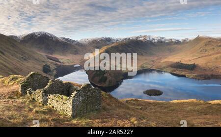 Haweswater reservoir in the English Lake District from the Old Corpse Road, looking across to Riggindale and High Street on a bright cold winter's day Stock Photo