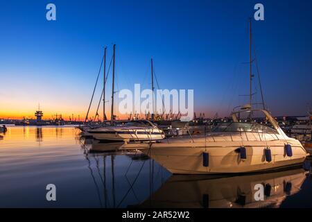 Yacht port and beautiful sunset over Varna, Bulgaria. Sailboat harbor, many beautiful moored sail yachts in the sea. Stock Photo