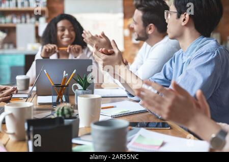 Young business team clapping hands on meeting, close up Stock Photo