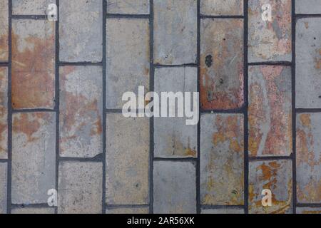 A floor of old, dirty  and weathered Industrial tiles. Background image. Stock Photo