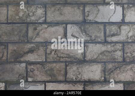 A floor of old, dirty  and weathered Industrial tiles. Background image. Stock Photo