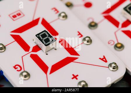 Seven-segment indicator. Display device for digital information. Studying physics and electrical engineering at school. Digital LED indicators, roboti Stock Photo